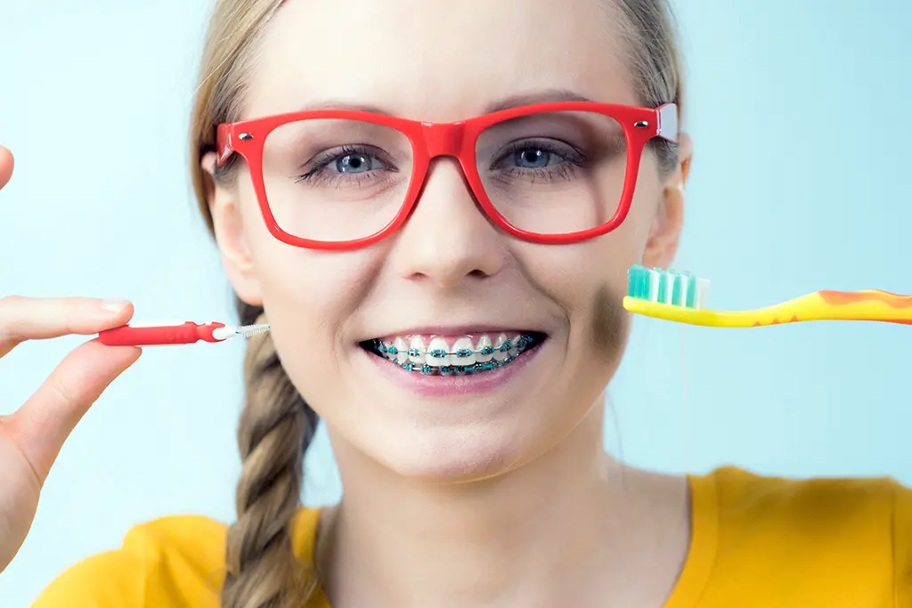 Braces and Halloween candy can work together for fun but be sure to brush up 30 minutes after eating.
